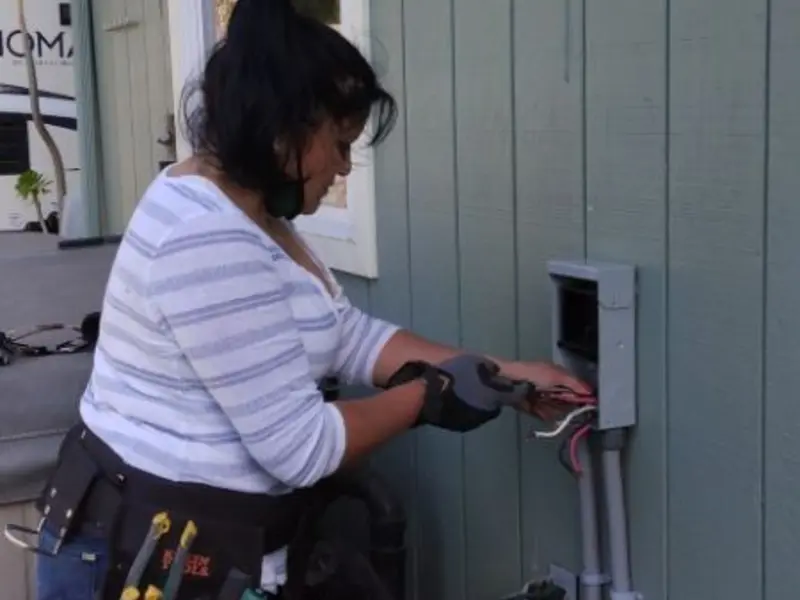Licensed electrician wiring an exterior subpanel in Lincoln