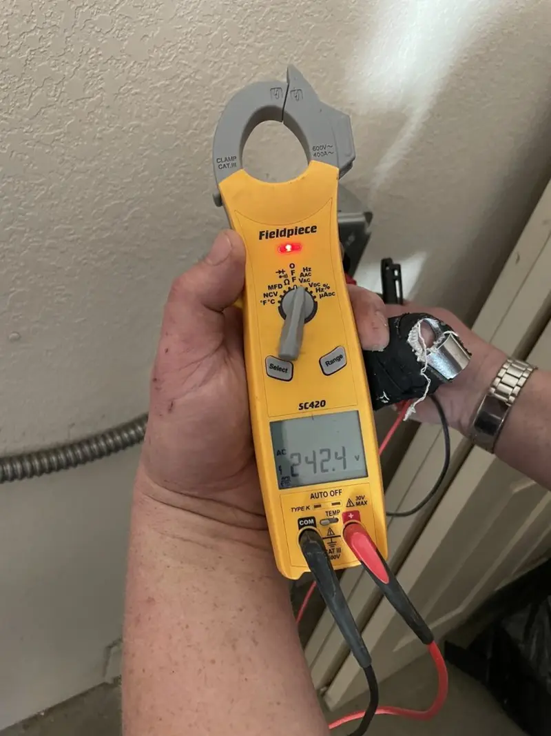 Voltage testing with clamp meter during Outlet Installation in Lincoln